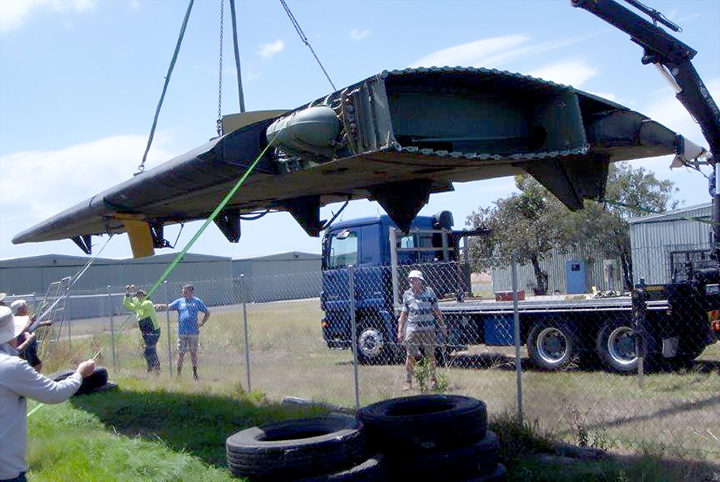 DHC4 Caribou A4-228 crane lifting wing prior to fitting
