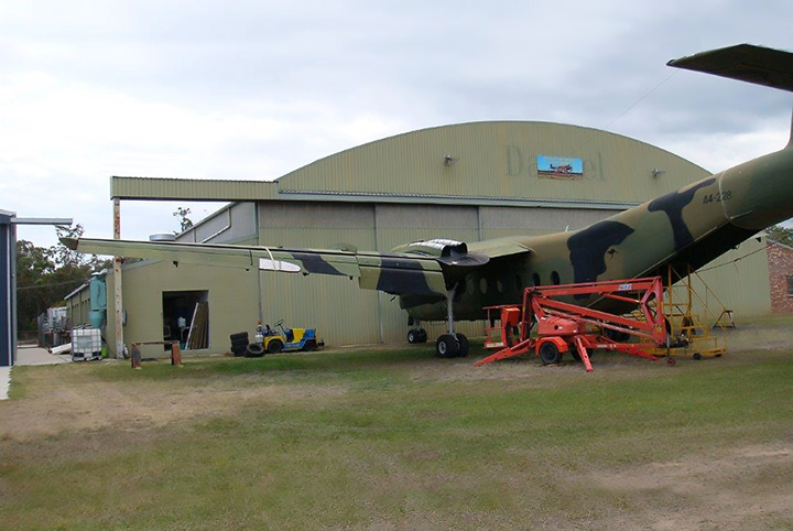 DHC4 Caribou A4-228 in front of AAHC Qld hangar