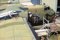 DHC4 Caribou A4-228 volunteer working on wing