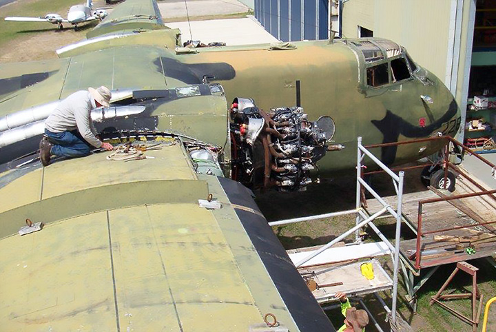 DHC4 Caribou A4-228 volunteer working on wing