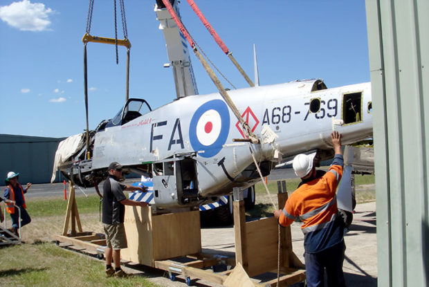 Mustang a68-110 fuselage being lowered into mounting jig    | warbirds online