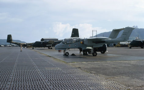 A US Air Force North American Aviation OV 10A Bronco aircraft with a red and yellow banded spinner and the tail number 67 14639 on the tarmac at Vung Tau air base having been unloaded