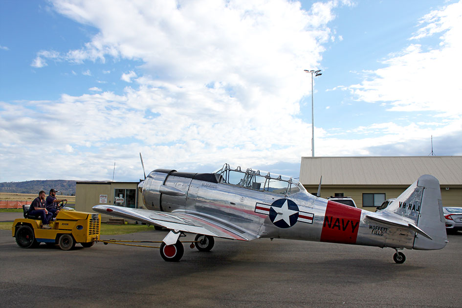 North American T-6G Harvard VH-HAJ is moved out of the hangar
