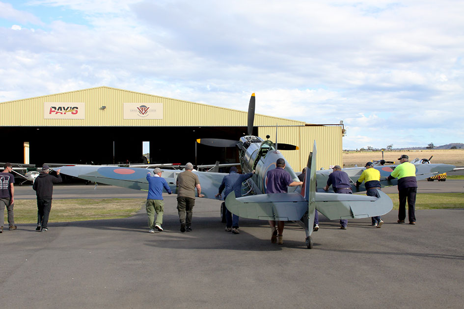 Spitfire MH603 is carefully pushed out of the hangar by Pays & VFR staff and HFC volunteers